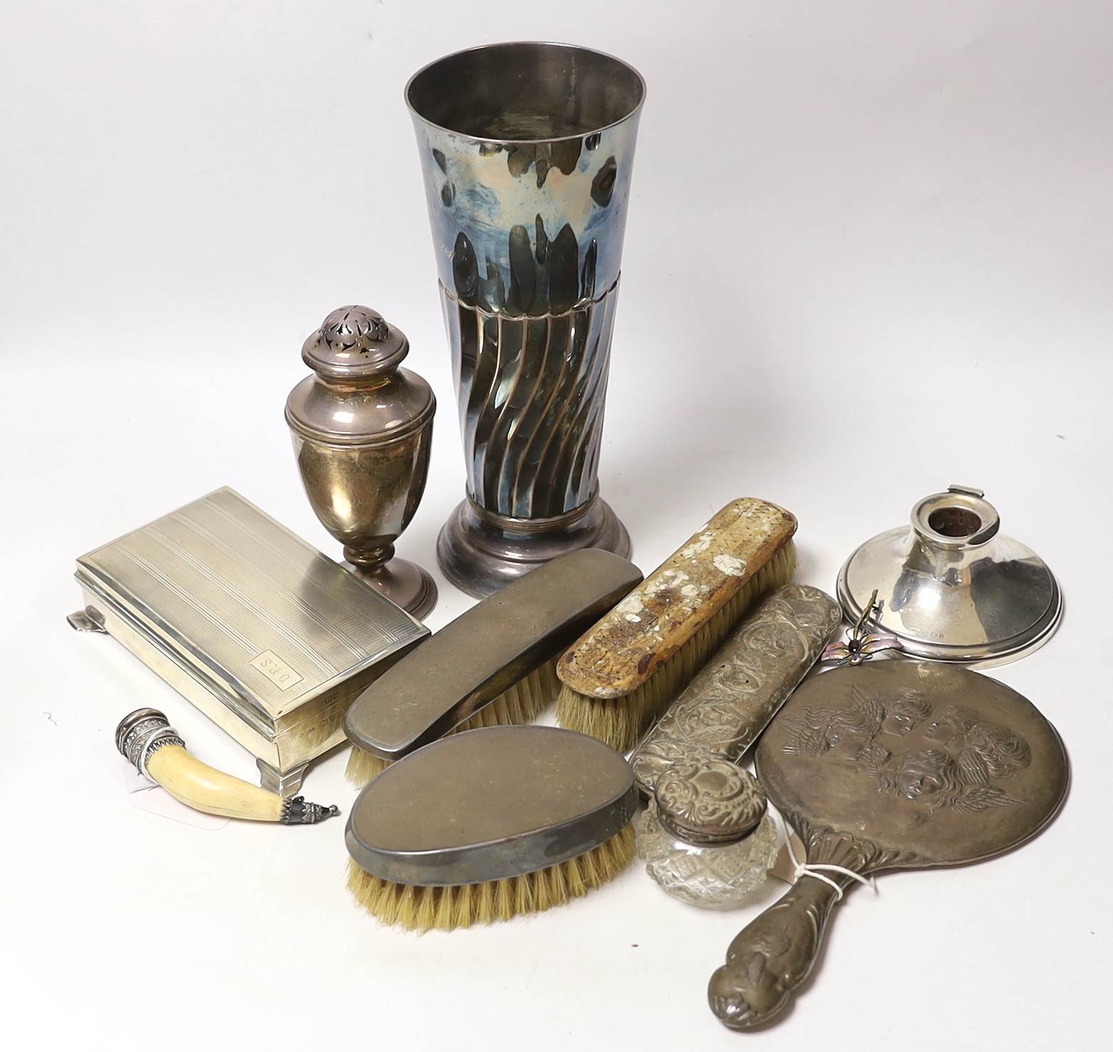 A group of sundry silver including an Edwardian demi-wrythened vase, London, 1901, 24.3cm, mounted hand mirror and three brushes, cigarette box, sugar caster and a damaged inkwell, together with a 1970's silver and ename